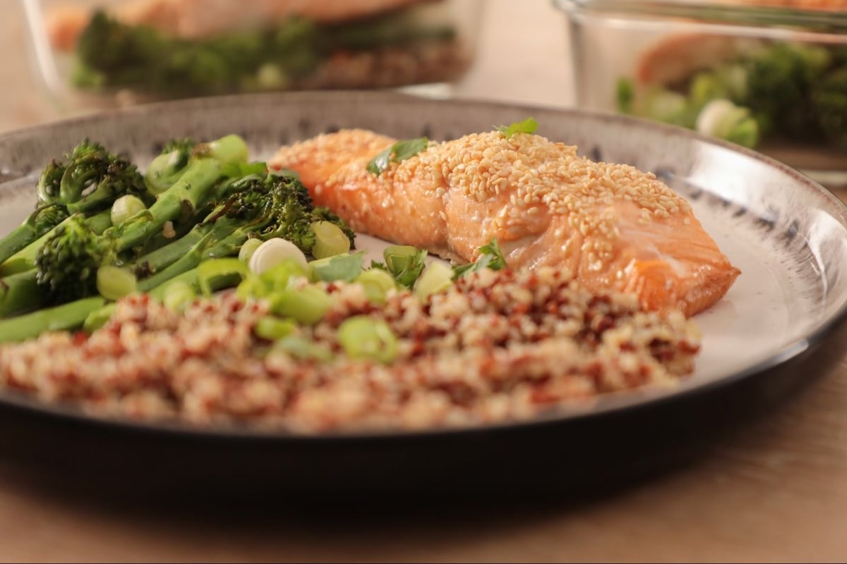 Sesame-crusted salmon fillet with quinoa and broccoli on a silver plate