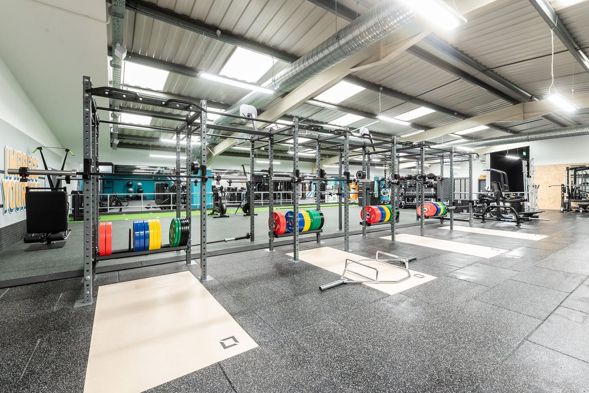 PureGym Cardiff Western Avenue: Squat racks and dead lift flooring with colourful weight plates.