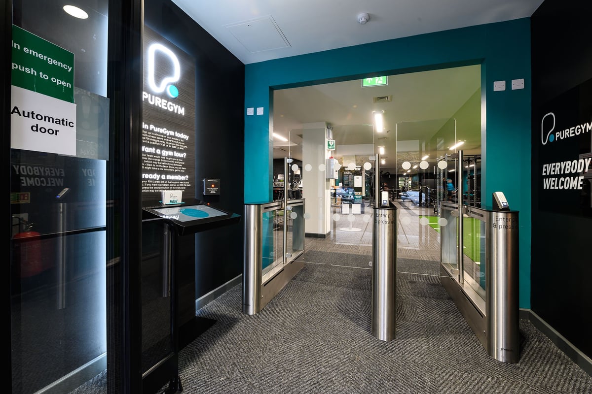 PureGym Didcot: Front entrance with automatic doors, turnstiles, and signage for gym.