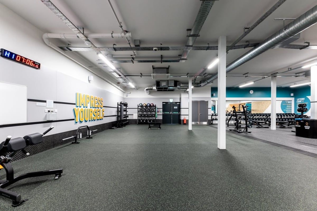 PureGym Heanor: Resistance machines, weight racks, free weights, rubberized flooring in a brightly lit gym studio.