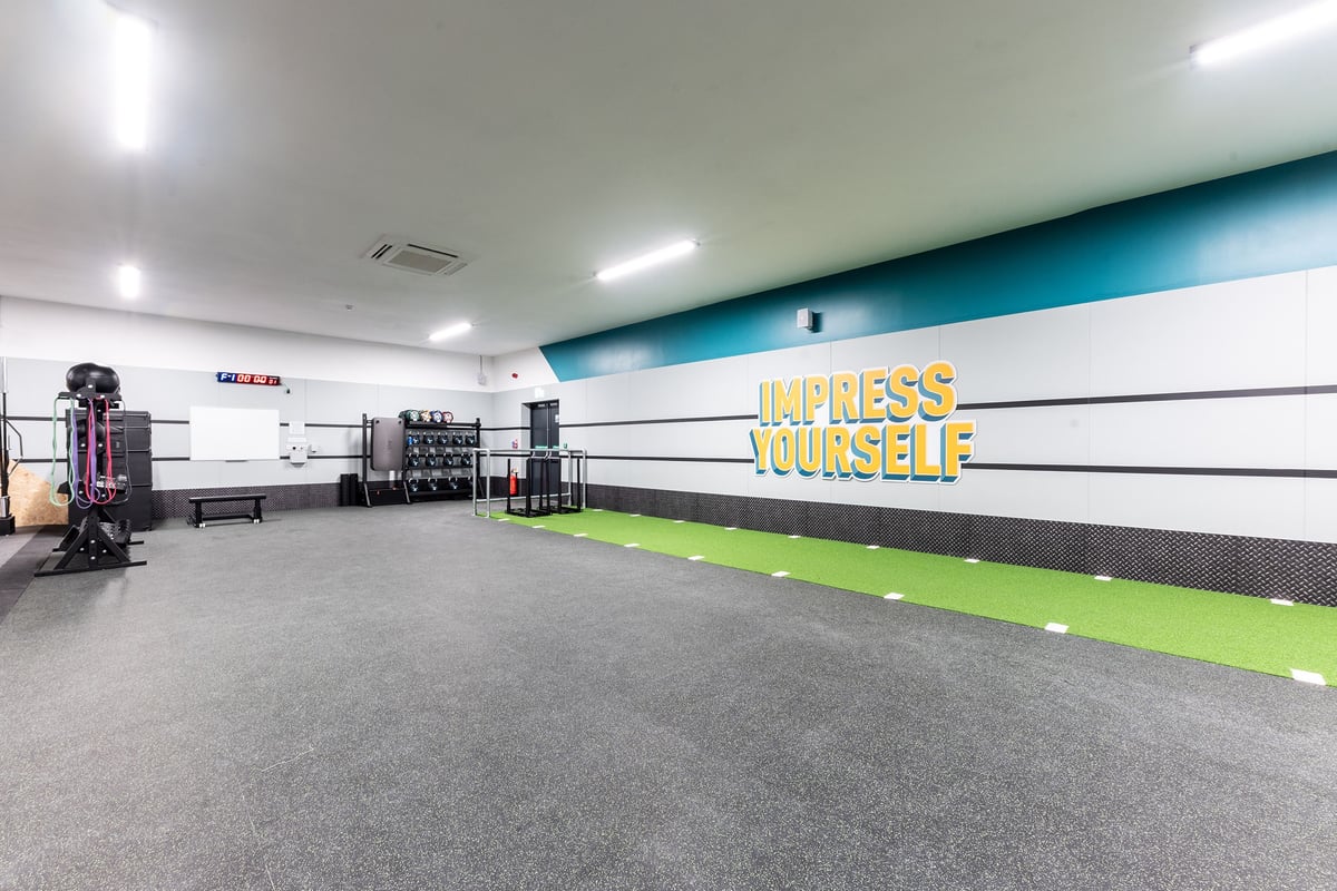PureGym Selby: Rubberized gym floor, resistance machines, weight racks, motivational wall branding.