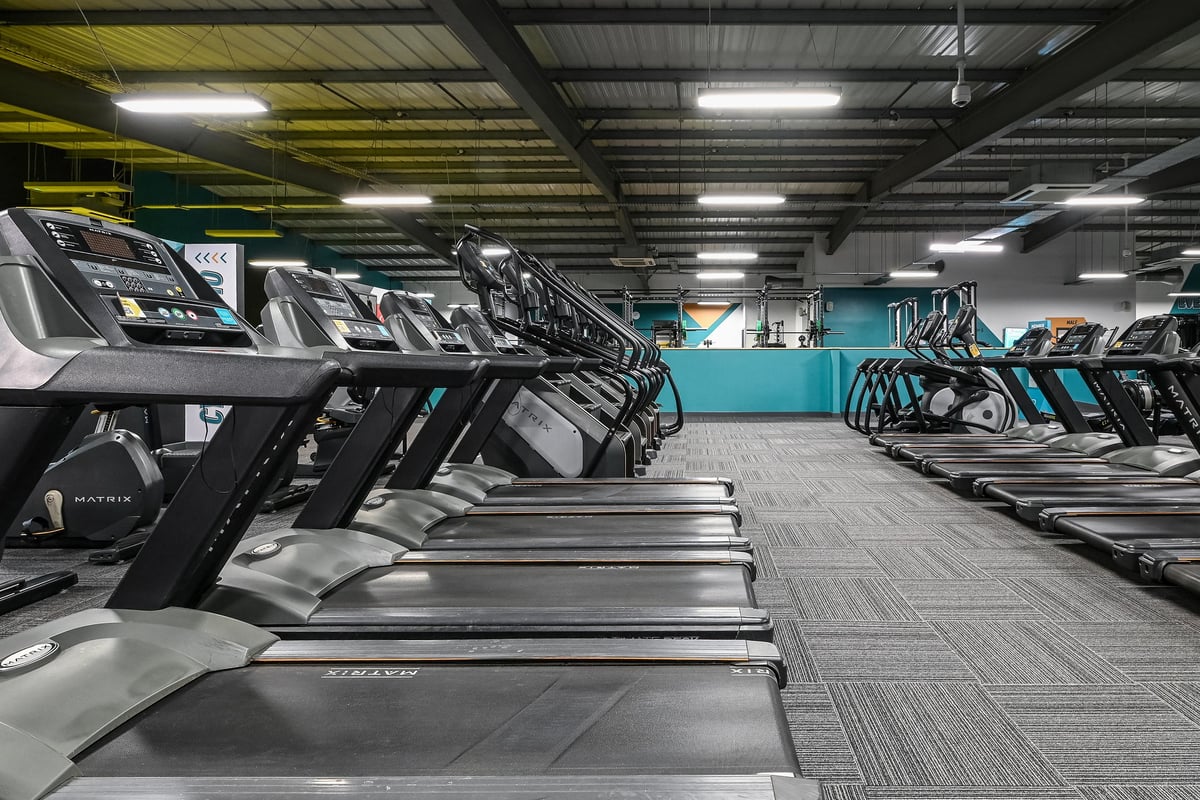 PureGym Canterbury Sturry Road: Rows of treadmills, ellipticals, and other modern cardio equipment in a gym setting.