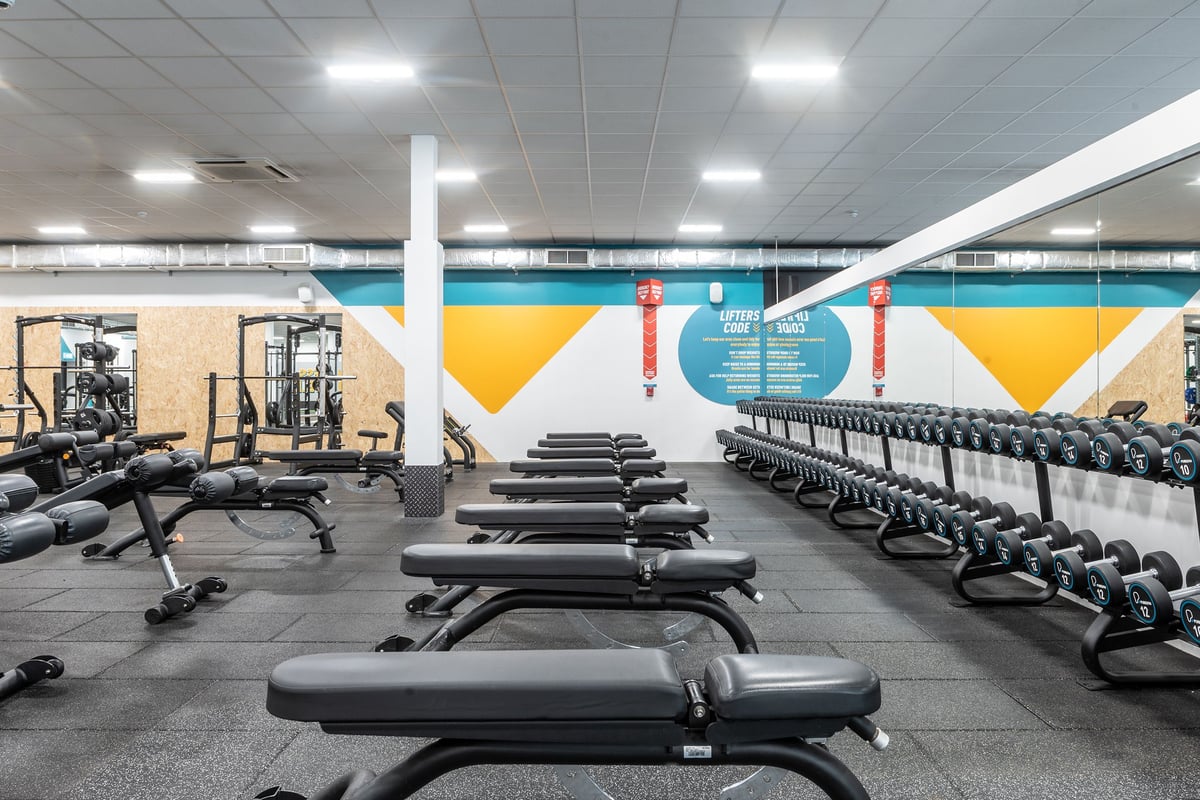 PureGym Coventry Warwickshire Shopping Park: Rows of benches, freeweights, weight machines and mirrors.