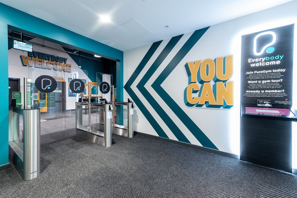 PureGym Bracknell: Entrance area with turnstiles, motivational signage, and an "Everybody Welcome" logo.