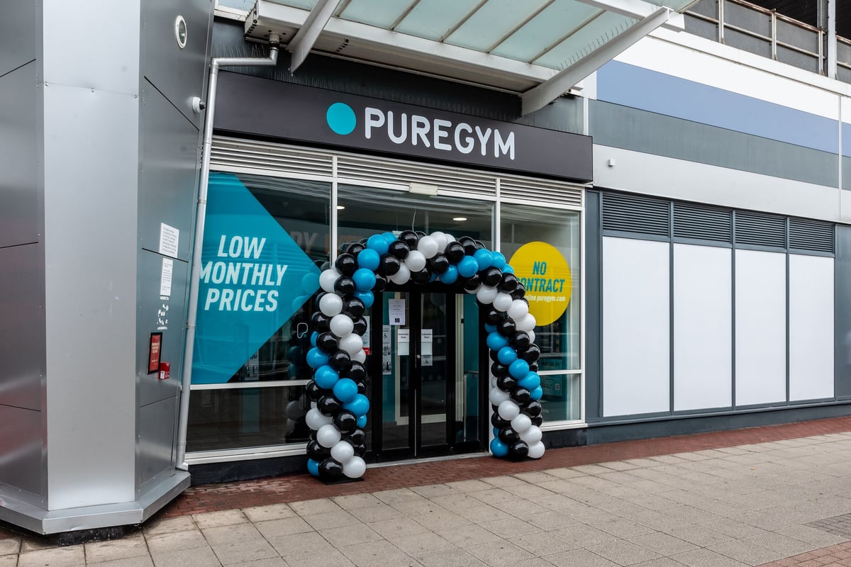 PureGym Loughborough: Gym entrance with balloon arch welcoming new members, advertising low monthly prices.