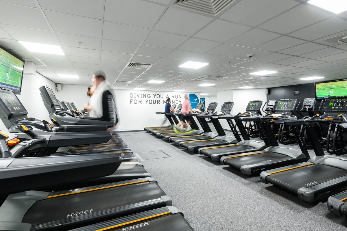 PureGym London Moorgate: Rows of treadmills and other cardio machines in a spacious gym area.