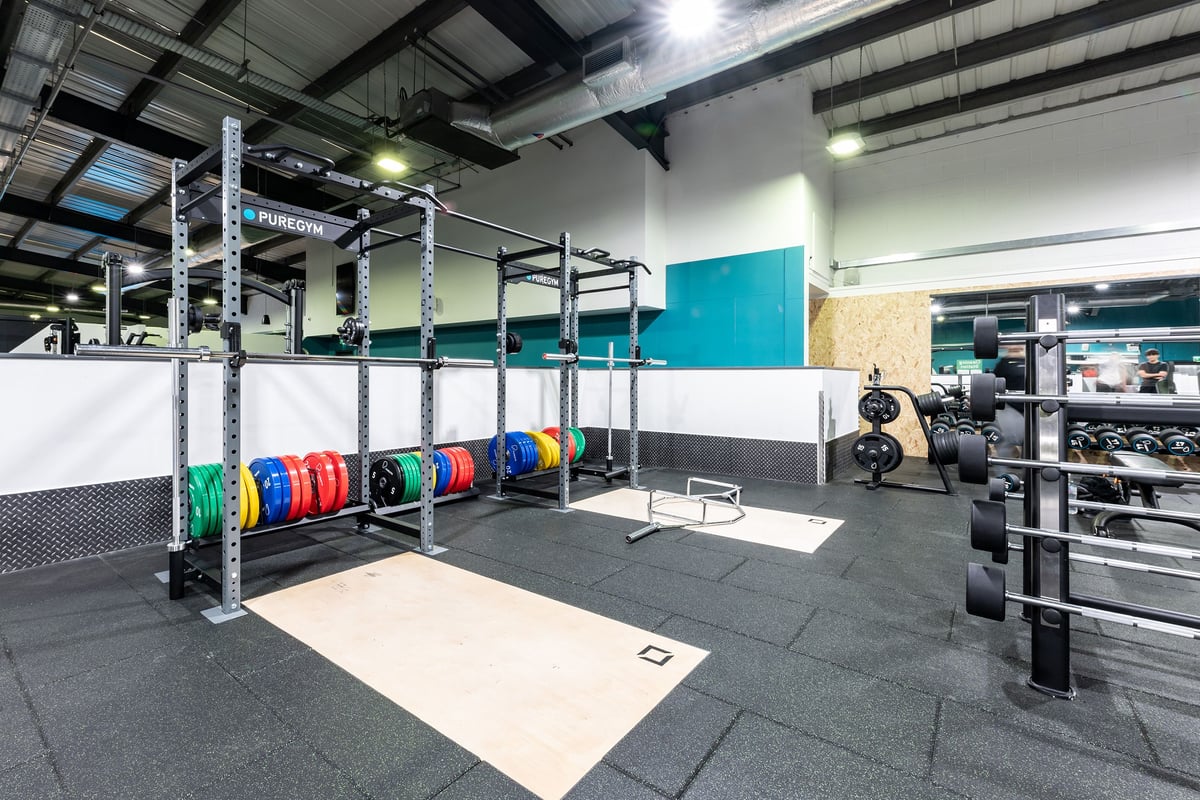 PureGym Lincoln St Marks Centre: Weight racks, colourful bumper plates, plyo boxes, rigs, and rubber flooring in a gym setup.