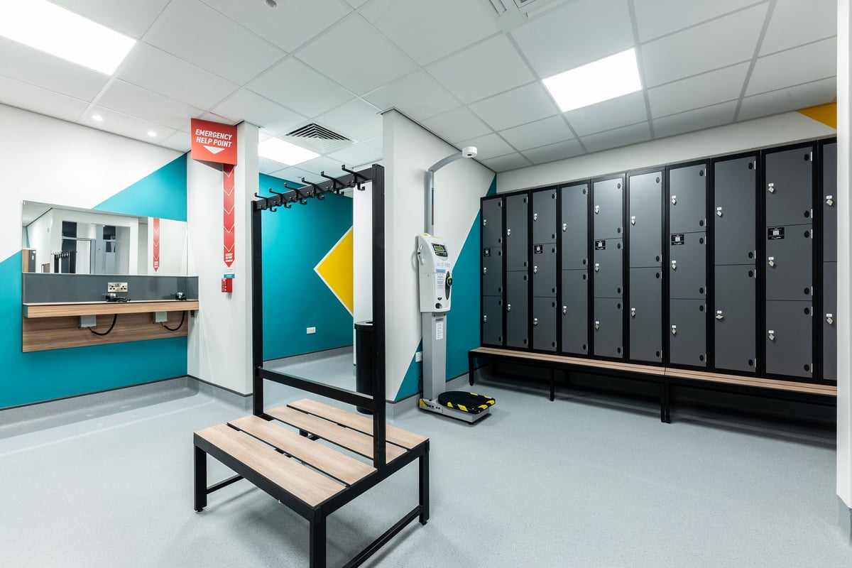 PureGym Byfleet: Lockers, benches, and open space for workout sessions.