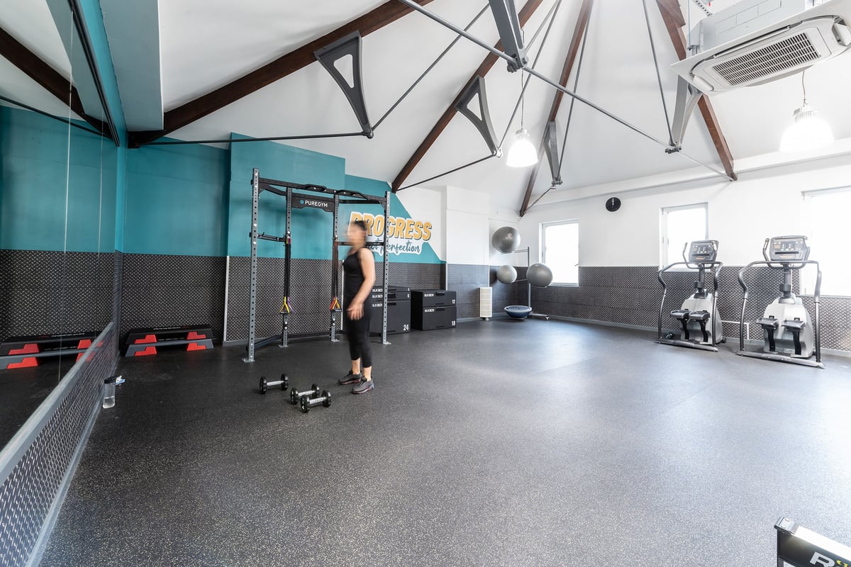 PureGym London Bayswater: Functional training rig, rubberized floor, weight racks, and mirrored walls.