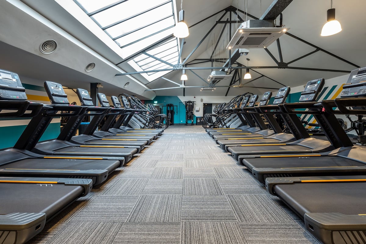 PureGym London Marylebone: Rows of treadmills facing mirrors, skylights providing natural lighting in the fitness studio.