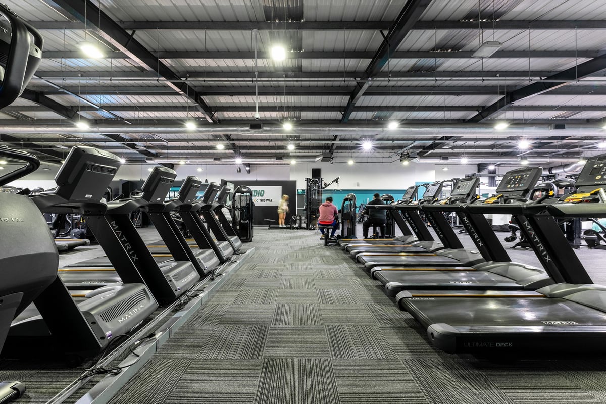 PureGym Lincoln St Marks Centre: Rows of treadmills inside a well-lit gym space with industrial ceiling.