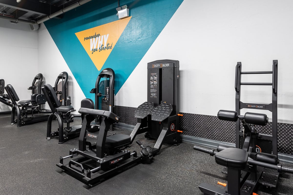 PureGym Manchester Spinningfields: Resistance training machines, weight racks, rubberized flooring in a gym studio.