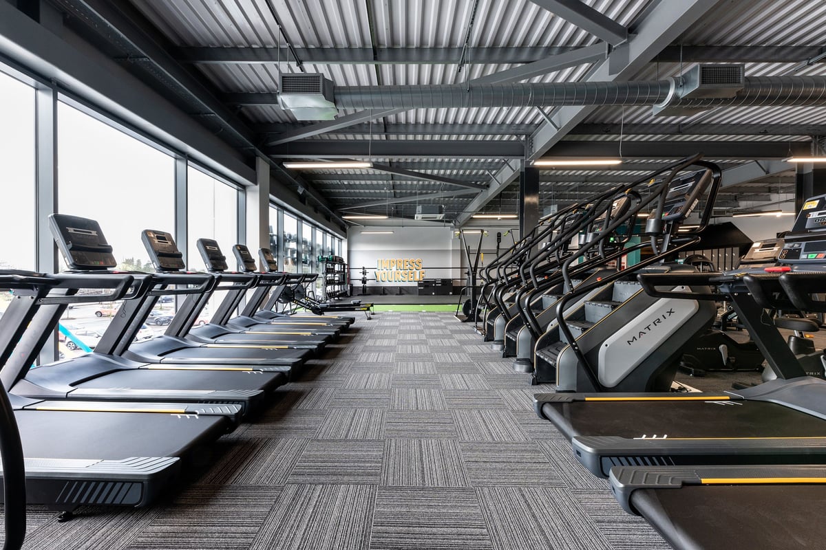 PureGym Yate: Rows of treadmills, stairmasters, ceiling with metal framing visible.