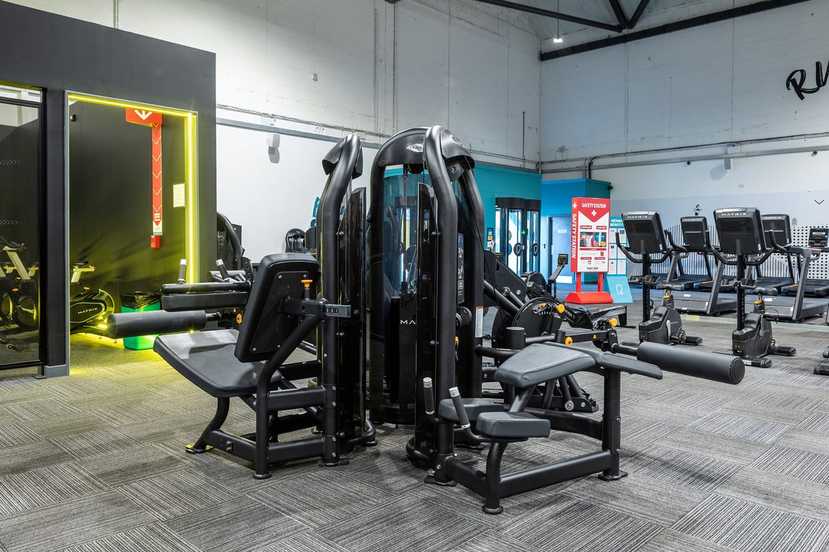 PureGym York: Multi-station weight machines, free weights, benches, and rubberized flooring in a gym setting.
