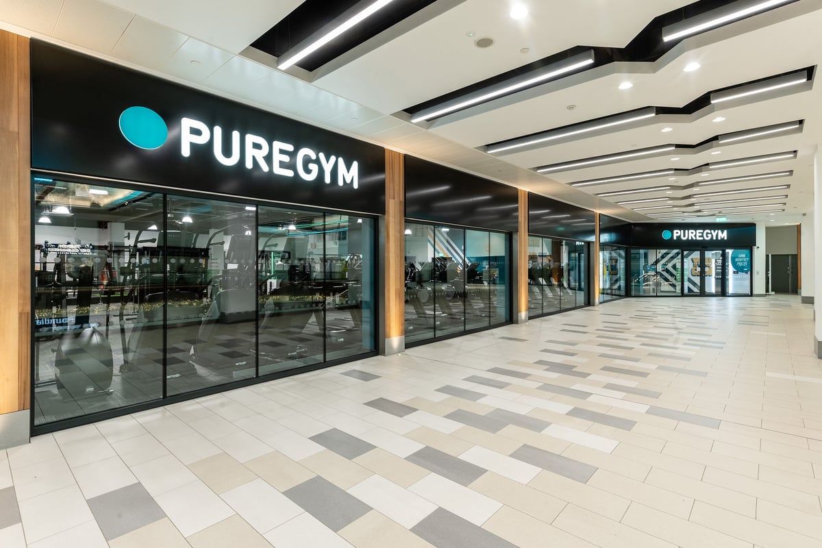 PureGym Bracknell: Puregym entrance with glass frontage, tiled flooring, and signage.