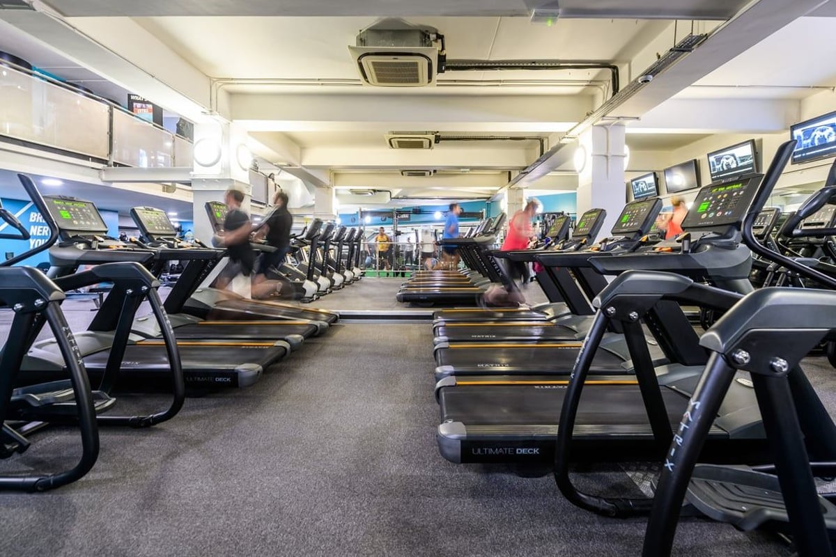 PureGym London St Pauls: Rows of treadmills, ellipticals, and other cardio machines in a well-lit gym interior.