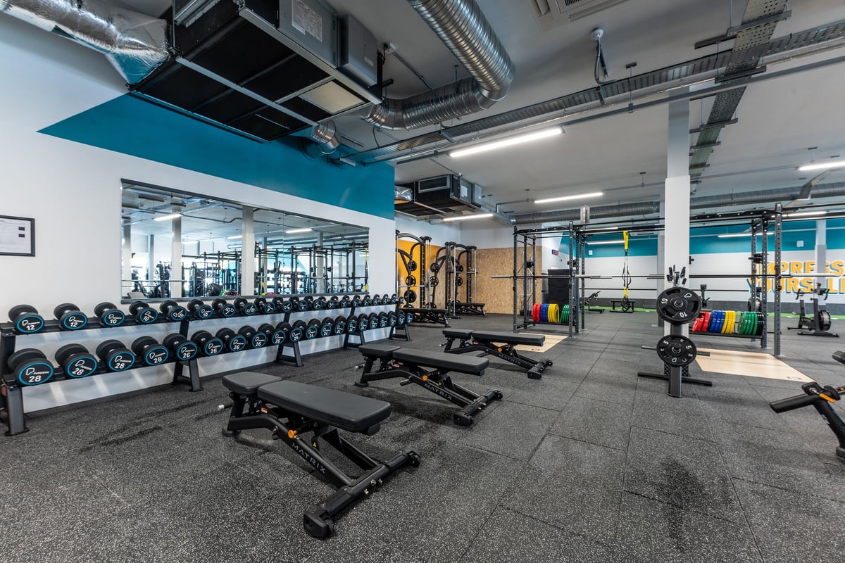 PureGym Crewe Grand Junction Retail Park: Gym space with weight racks, free weights, benches, rubberized floors, and mirrors.