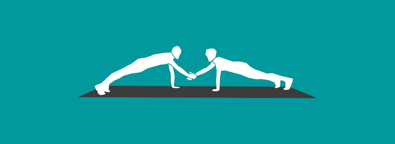 Two people doing push-ups while shaking hands on a mat against teal background