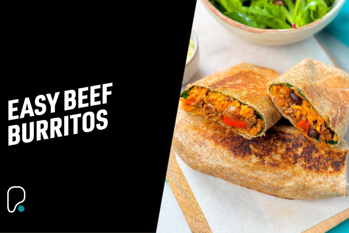 Two toasted beef burritos cut in half with rice, beans, and vegetables inside