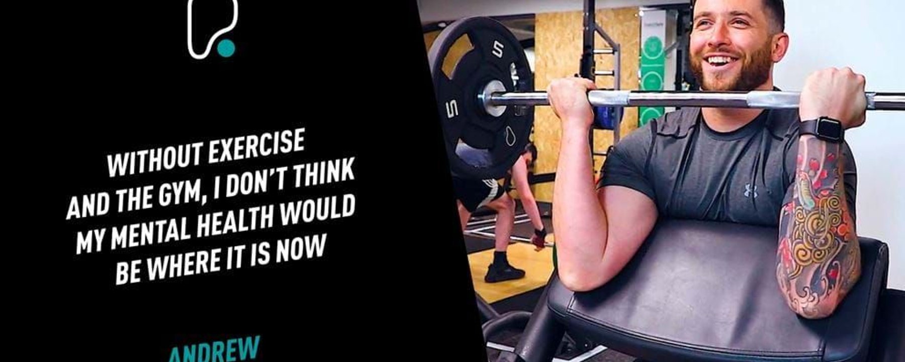 Man with tattoo lifting weights on preacher curl bench in gym smiling
