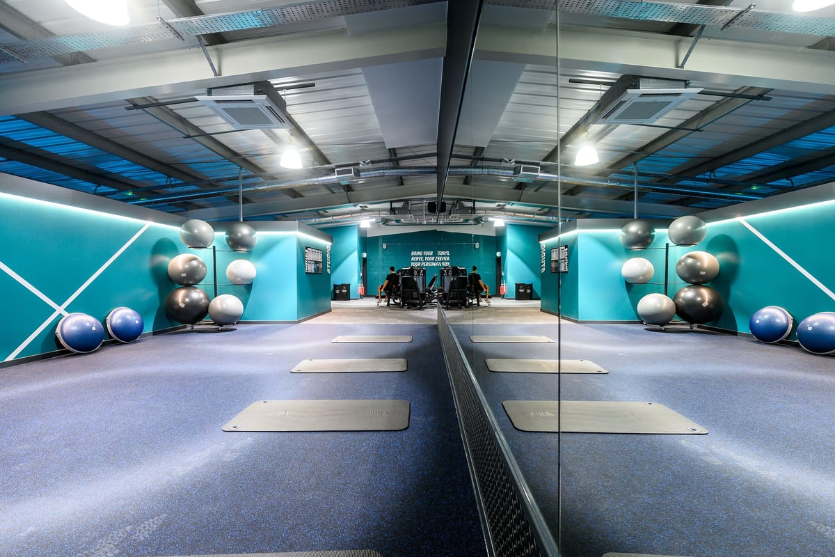 PureGym Bristol Abbey Wood Retail Park: Functional studio with colourful weight balls, mirrored walls, rubberized flooring.