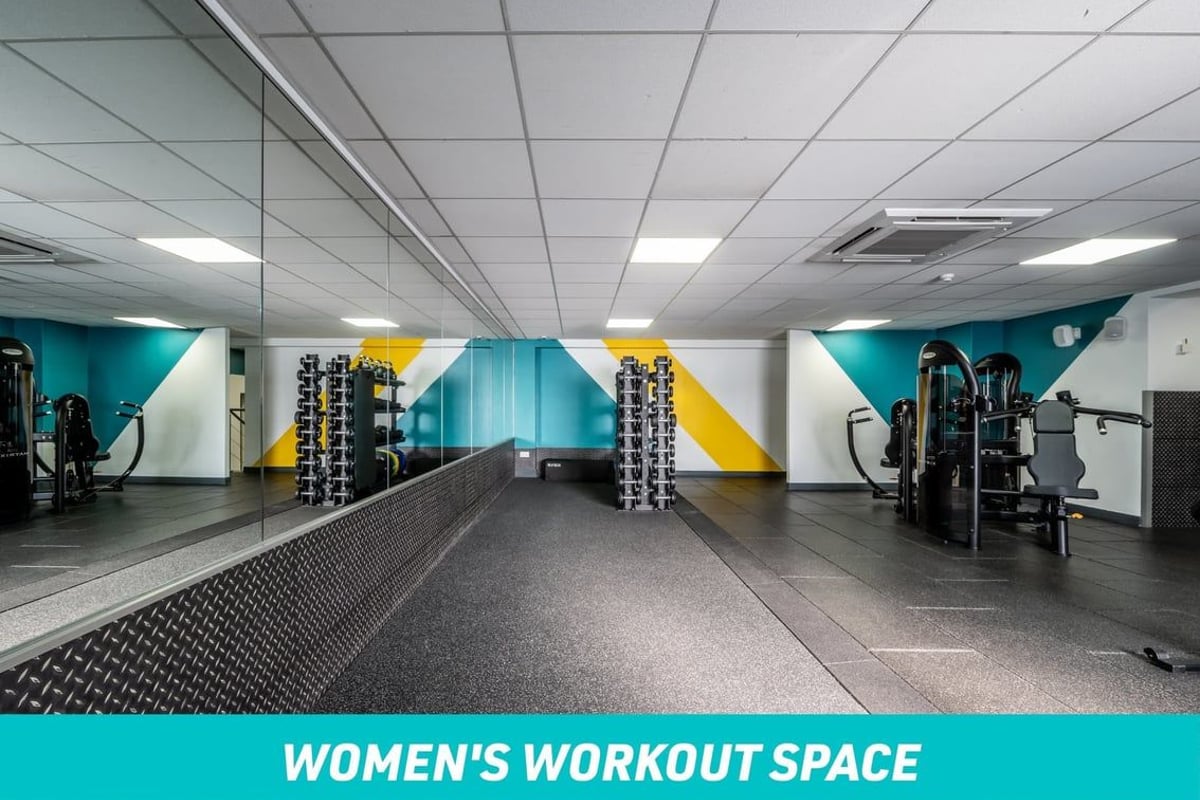 PureGym  Women's Workout Space: stretch area with large mirror, dumbbells and fixed pin machines