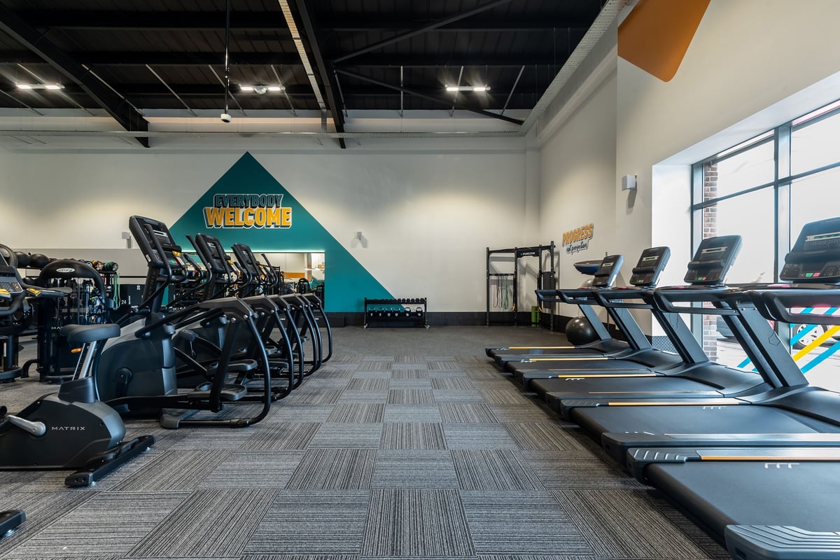 PureGym Durham Arnison: Rows of treadmills, ellipticals, stationary bikes, and weight training equipment.