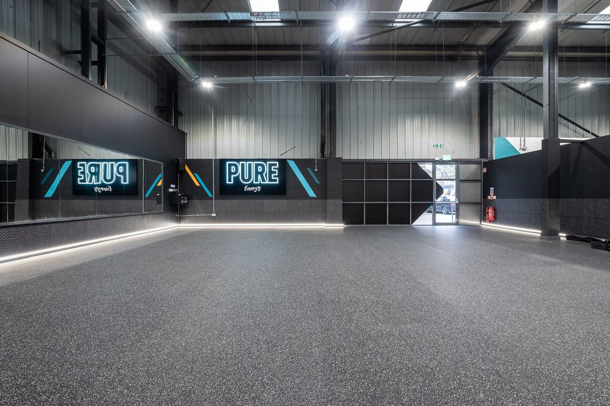 PureGym Dunfermline: Empty gym studio, mirrored walls, rubberized flooring, signage reading "Pure" and "Fuel"