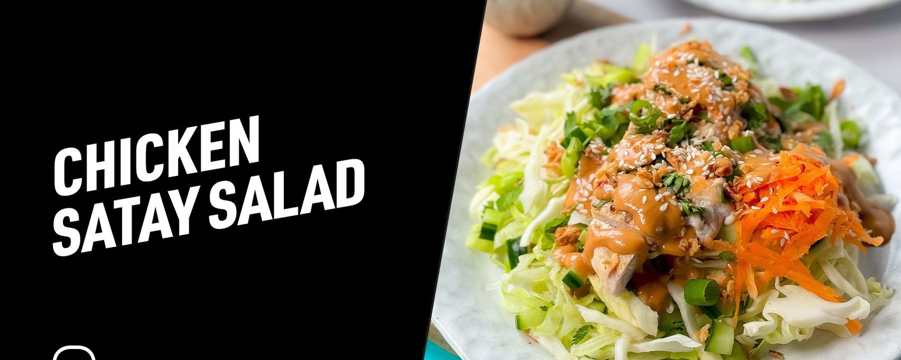 Chicken satay salad with shredded cabbage, carrot, green onions, and sesame seeds