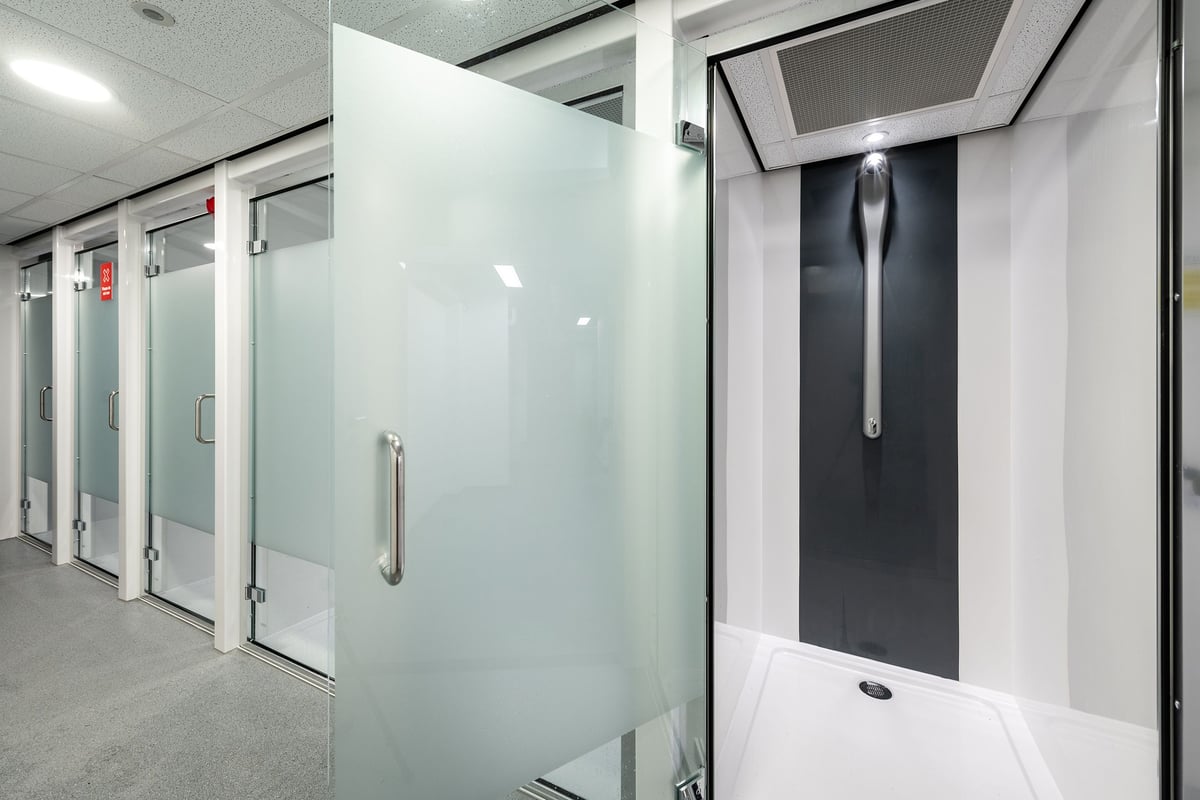 PureGym London Sydenham: Glass shower cubicles, recessed lighting, handles on doors