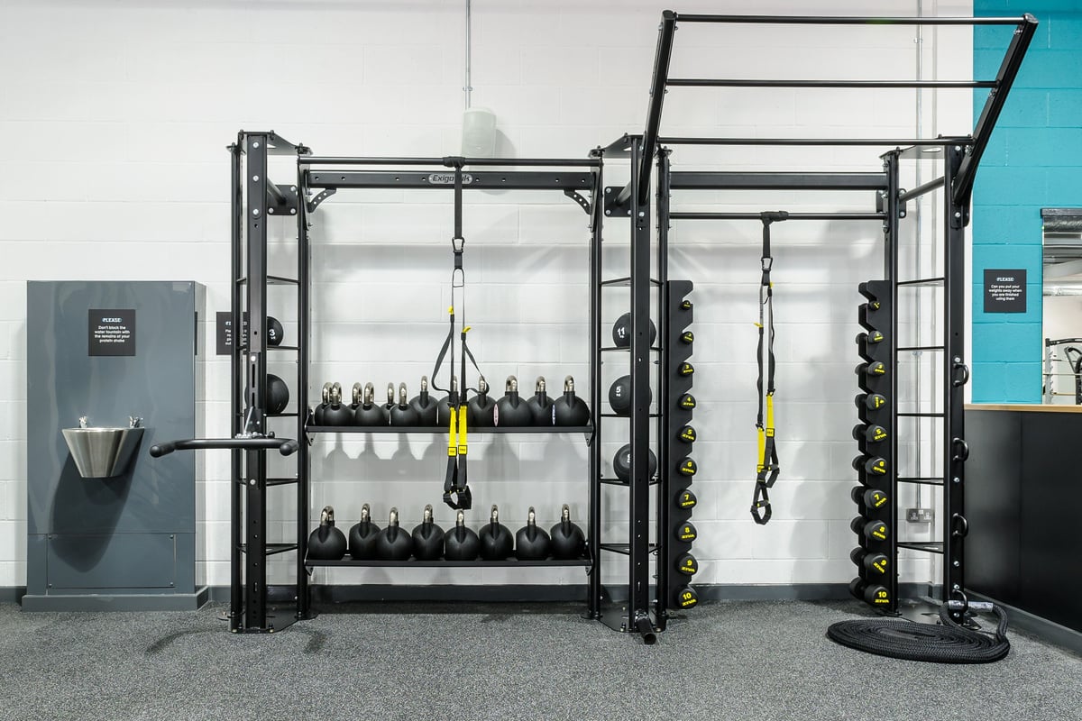 PureGym Leeds Regent Street: Functional training rig, dumbbell racks, weight plates, rubberized flooring in a gym setting.