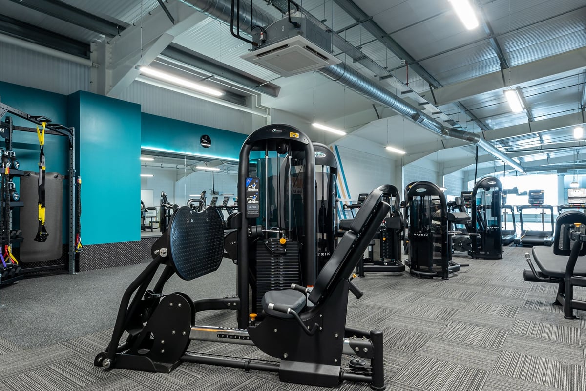 PureGym Liverpool Edge Lane: Fitness machines, weight racks, benches, and rubberized flooring in a brightly lit gym studio.