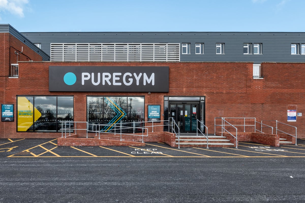 PureGym London Swanley: Gym entrance with signage, stairs, and parking lot.