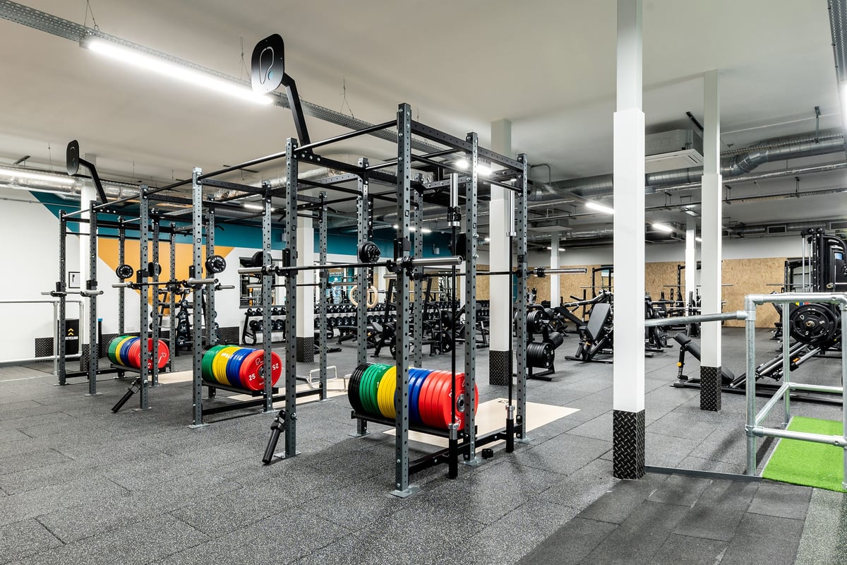 PureGym Solihull Sears Retail Park: Racks with weight plates in various colours, rubberized floors, and exercise equipment.