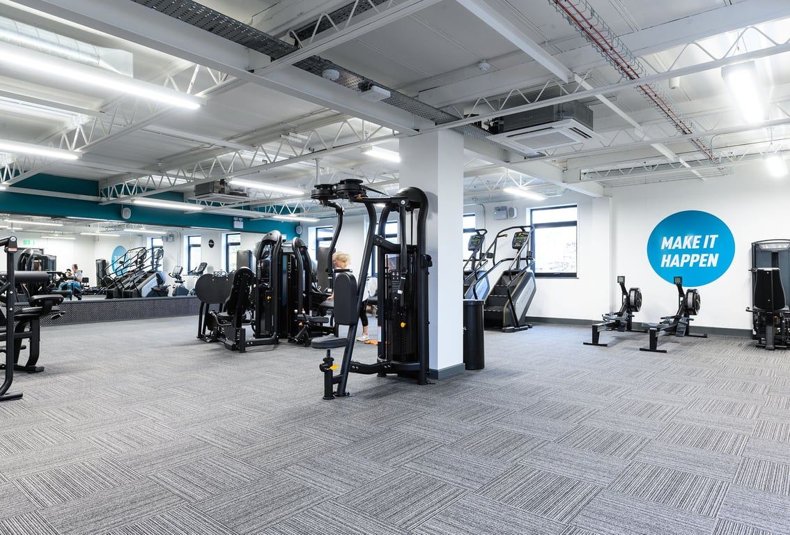 PureGym Didcot: Rows of resistance machines, weight stacks, benches, and rubberised flooring.