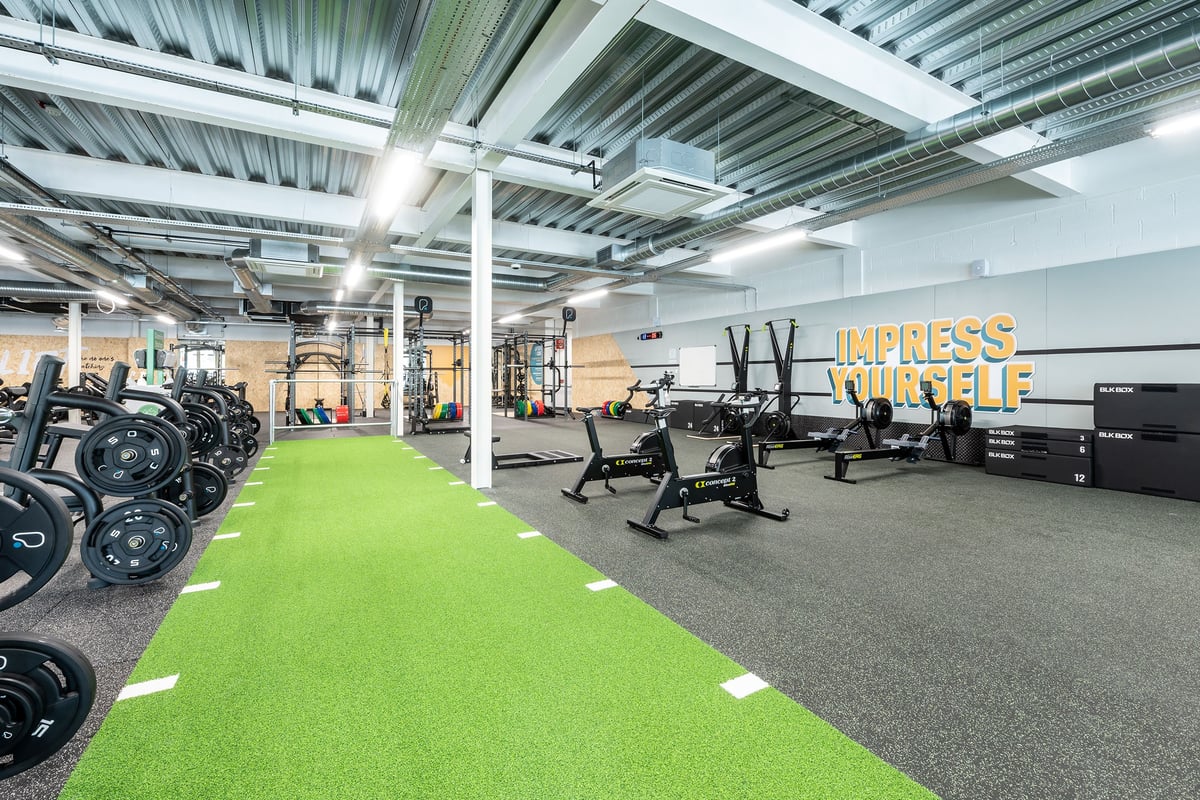 PureGym Cheshunt Brookfield Shopping Park: Free weights, resistance machines, green turf area, and weight racks.