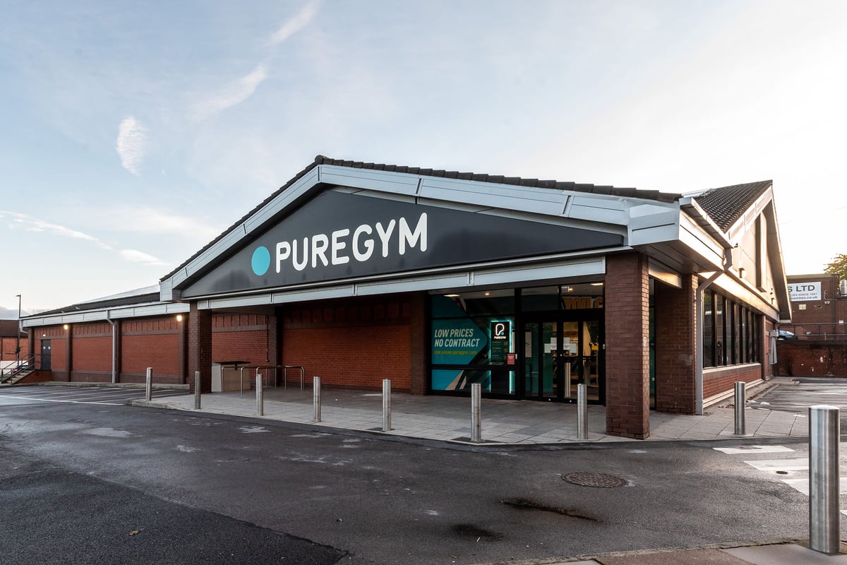 PureGym Tyldesley: Brick building frontage with Pure Gym signage and parking area.