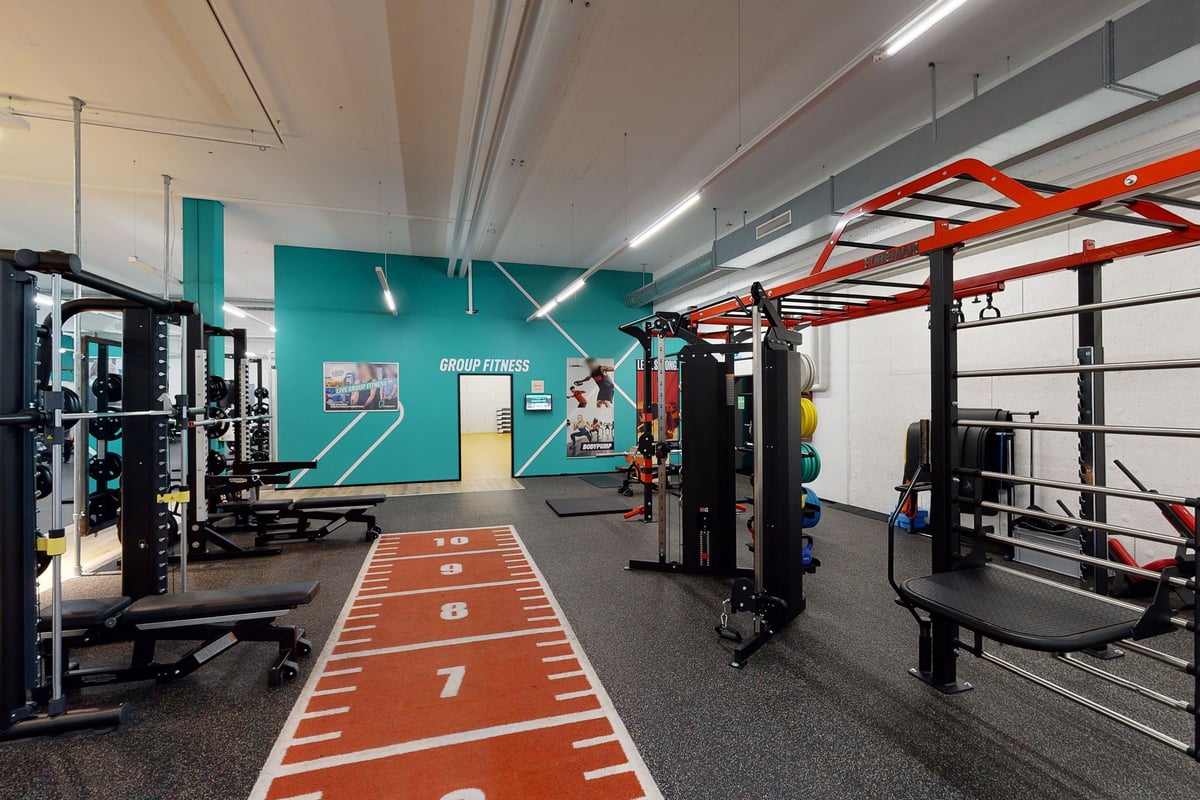 PureGym Pfäffikon: Hantelständer, Widerstandsmaschinen, Spiegel und gummierter Bodenbelag.