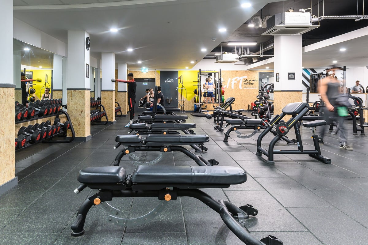 PureGym Oxford Central: Weight benches, dumbbells, resistance machines, and mirrored walls in a modern gym interior.