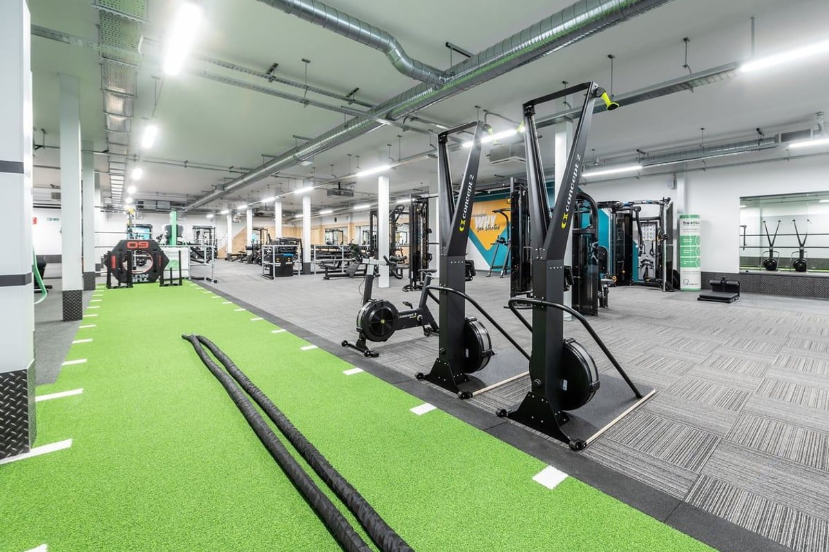 PureGym Yeovil Houndstone Retail Park: Functional training area with turf, weightlifting machines, rubberized flooring.