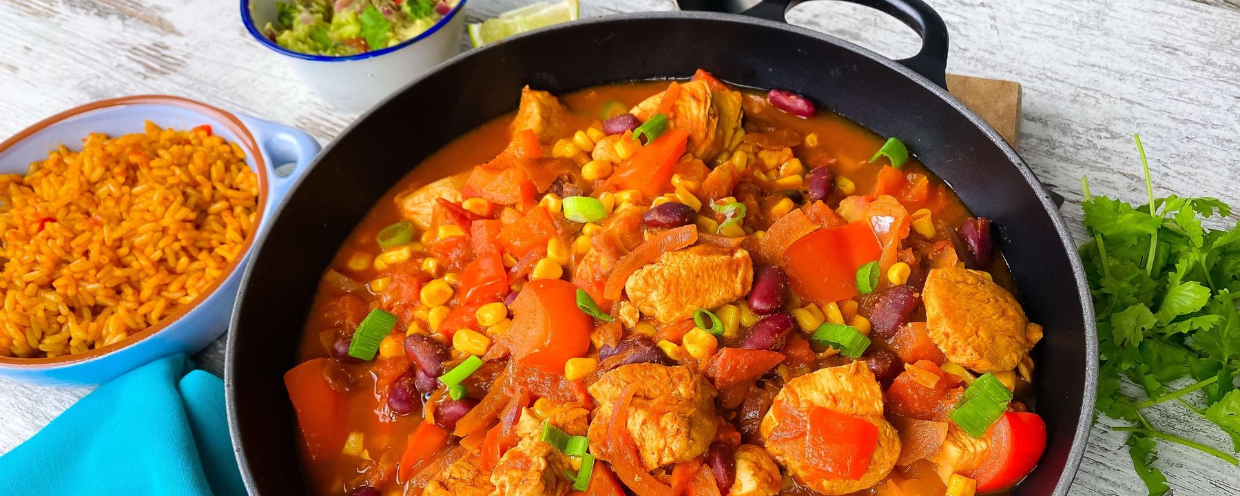 One pot chicken stew with peppers, beans and sweetcorn served with rice and salad