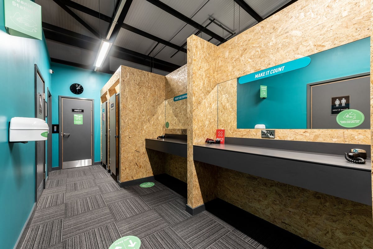 PureGym Kirkcaldy: Lobby with reception desk, seating area, lockers, and entrance gates.