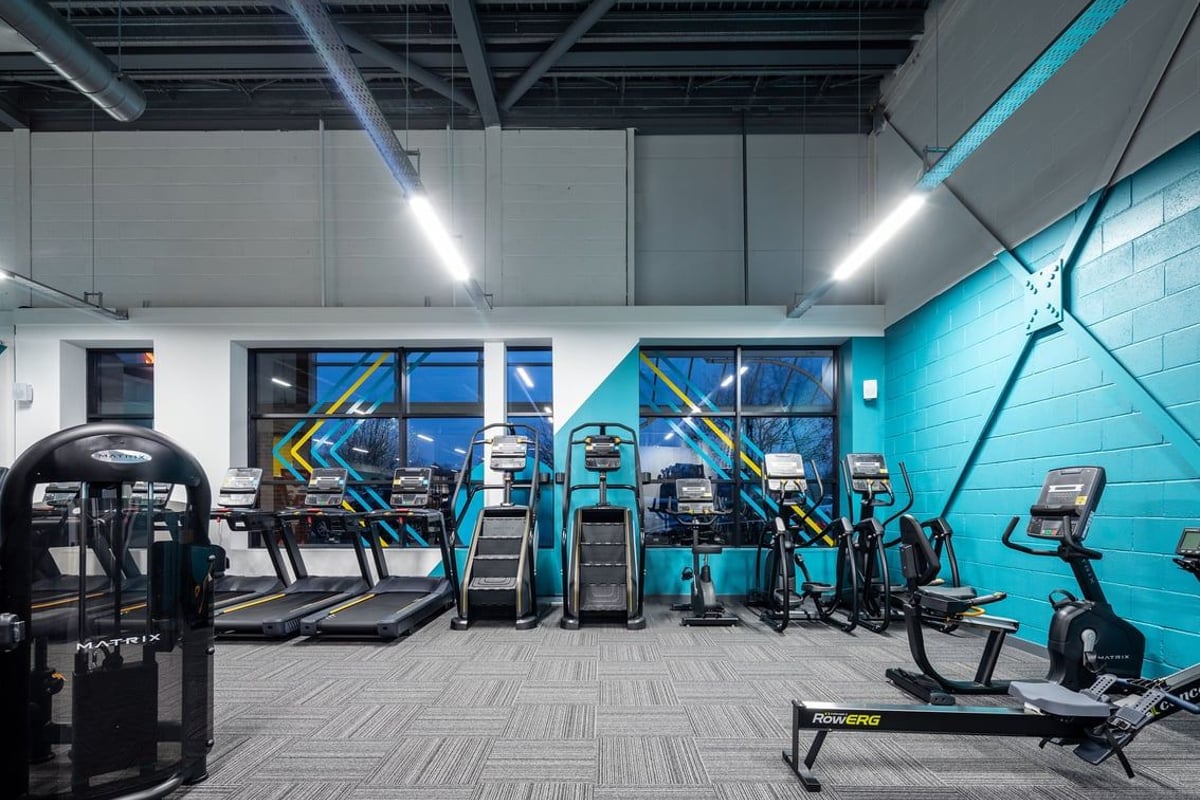 PureGym Wantage: Rows of cardio machines, strength equipment, and mirrored walls in a modern gym interior.