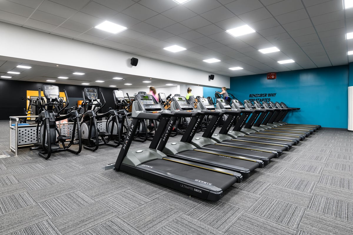 PureGym Aylesbury: Rows of treadmills, stationary bikes, and cross-trainers in a brightly lit fitness space.