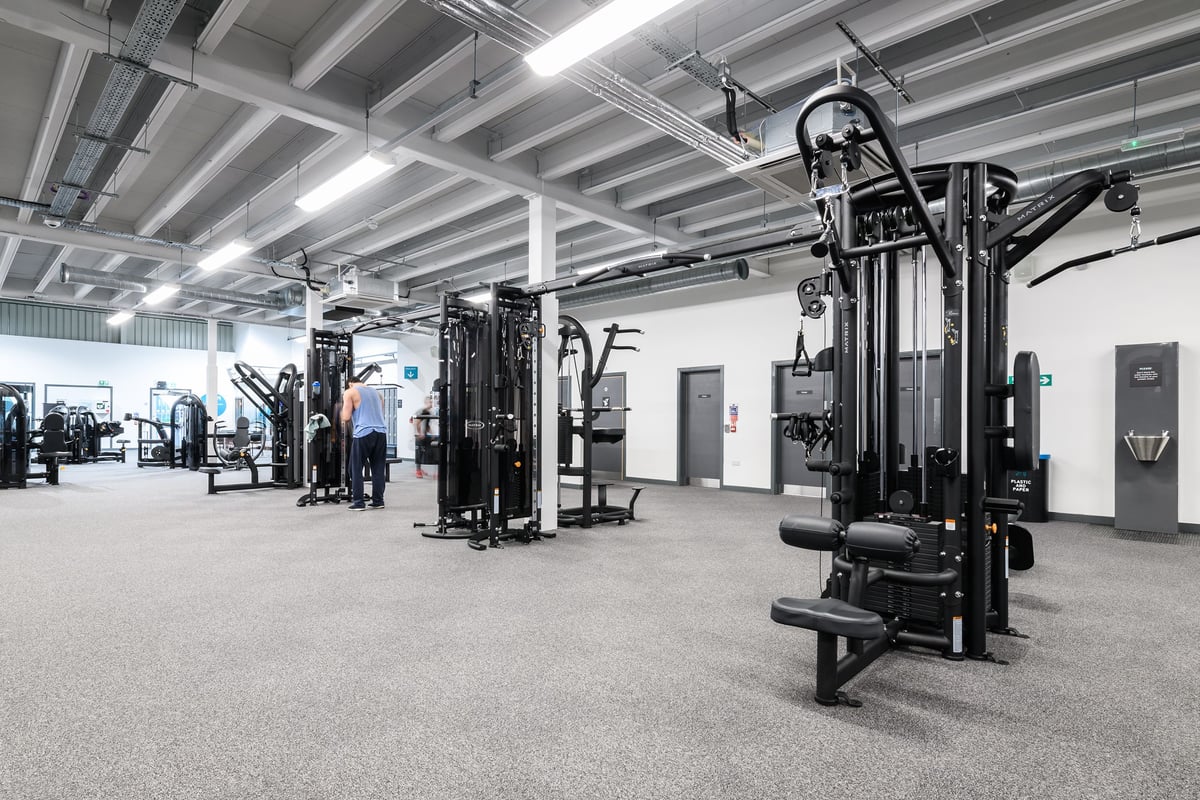 PureGym Aberdeen Wellington Circle: Weight machines, cable pulleys, and exercise benches in a well-equipped gym facility.