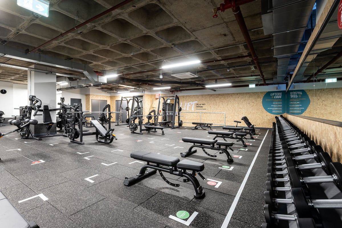PureGym Maidstone The Mall: Strength training area with weight racks, benches, free weights, and rubberized flooring.