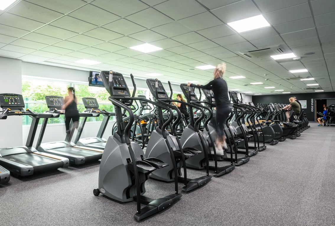PureGym Newcastle Longbenton: Rows of treadmills and other cardio machines lined up in a brightly lit gym.