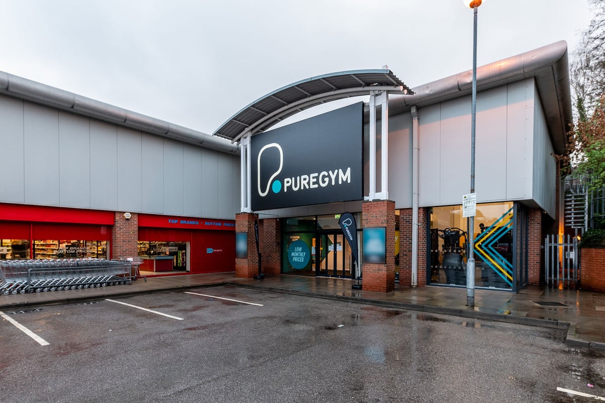 PureGym Heanor: The exterior of a PureGym fitness center, with a red awning and glass facade.