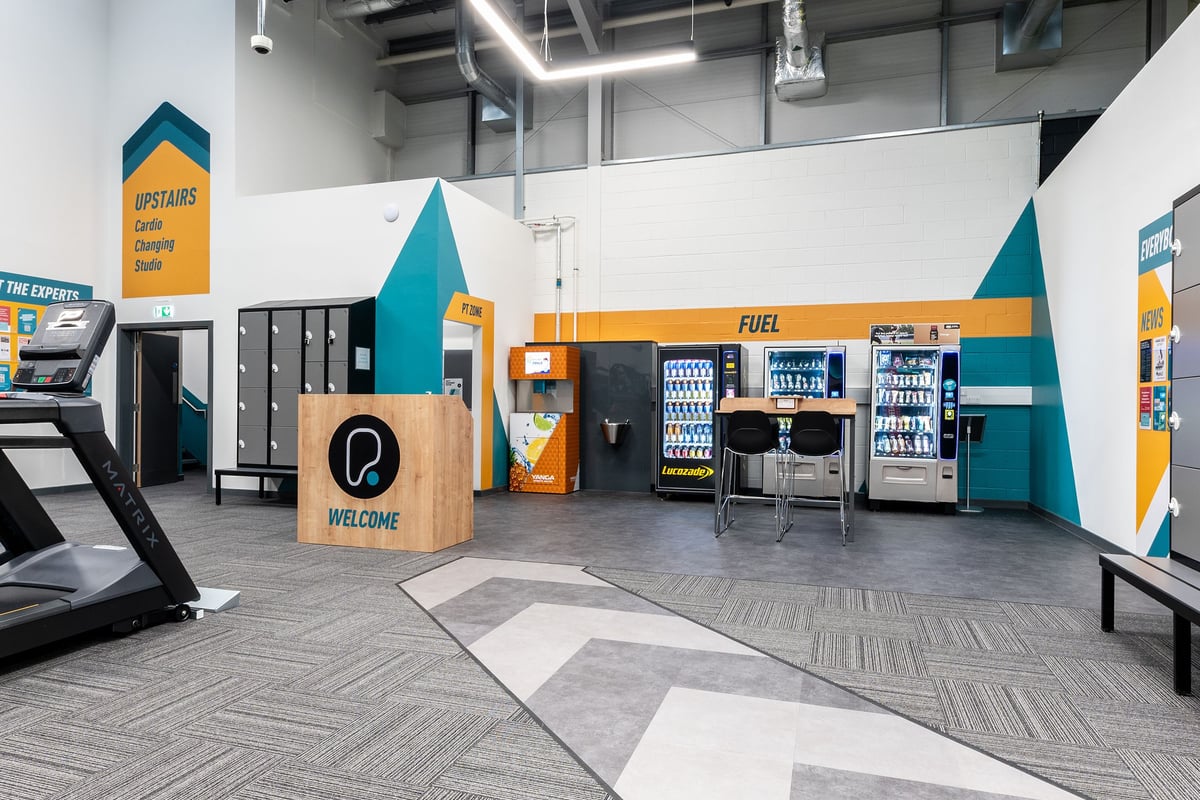 PureGym Broadstairs Westwood Gateway Retail Park: Gym studio with vending machines, seating benches, and self-service kiosks.