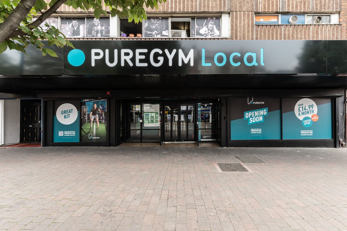PureGym London Leytonstone: Exterior of gym facility with signage, windows displaying exercise imagery, and entrance.